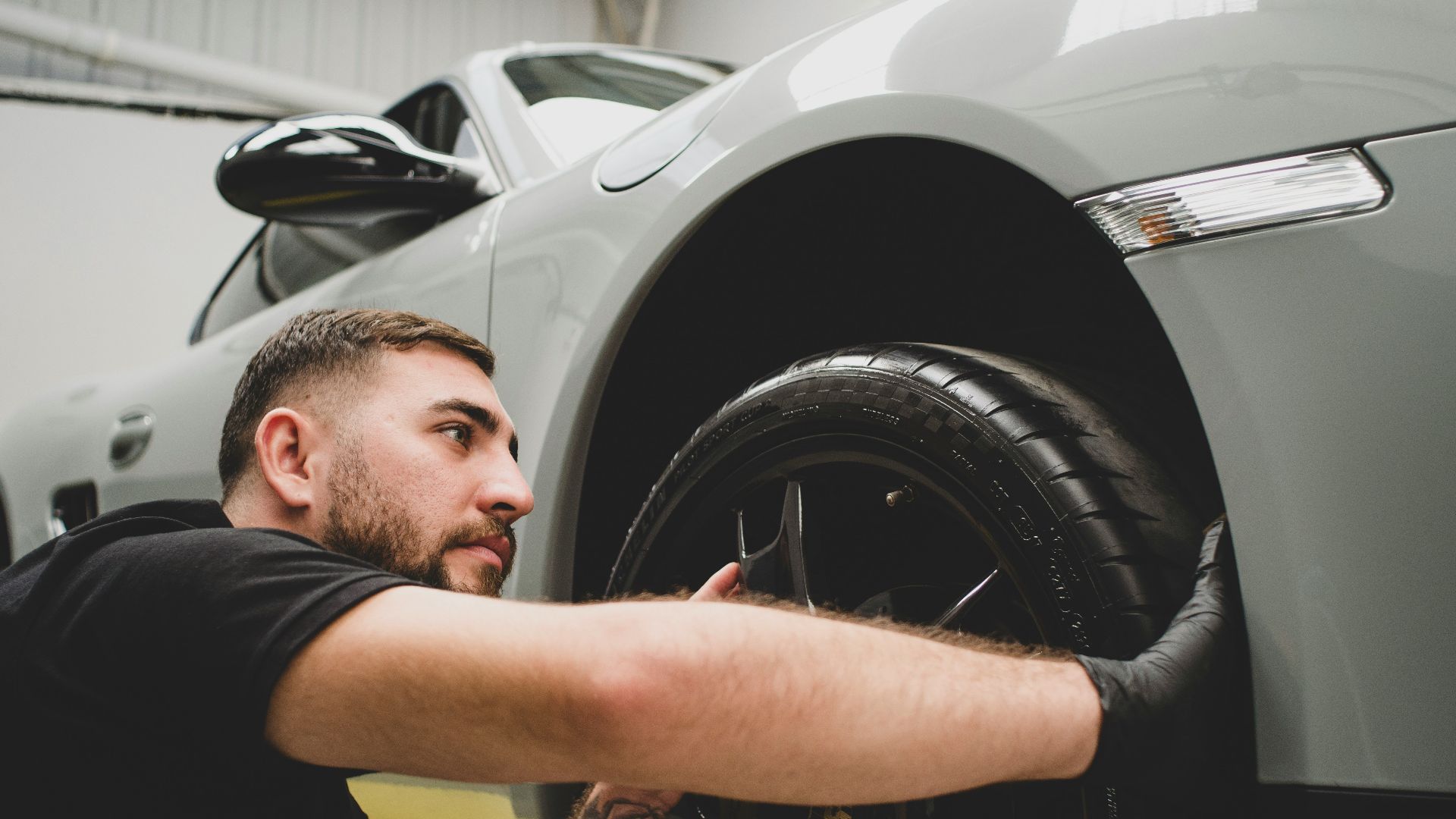 a man working on a car in a garage
