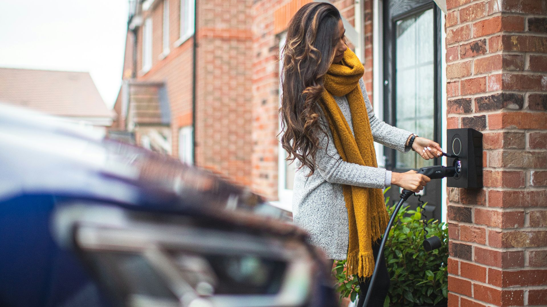 a woman is opening the door of her house