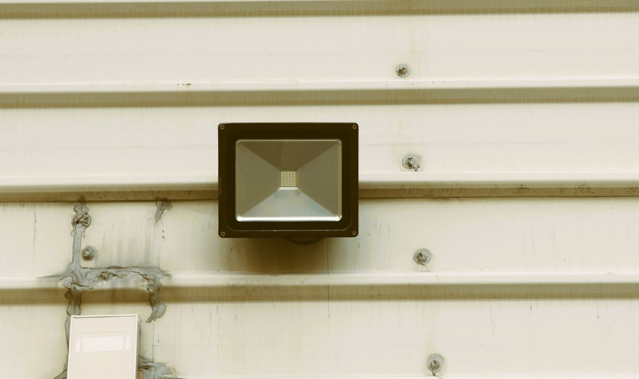 Industrial wall with security camera and light for enhanced safety