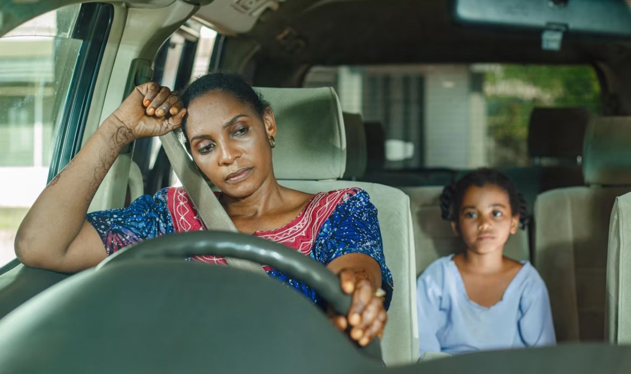 A parent driving car children to school 