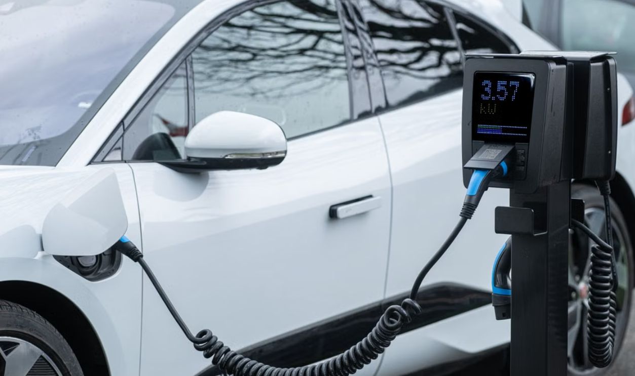 Close-up of an electric vehicle charging at a station, showcasing energy-efficient technology