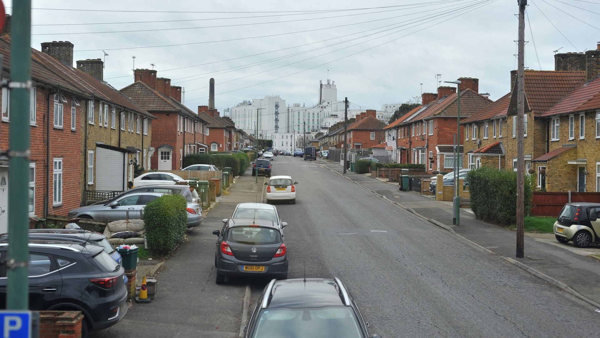 cars parked on the side of the road in a residential area