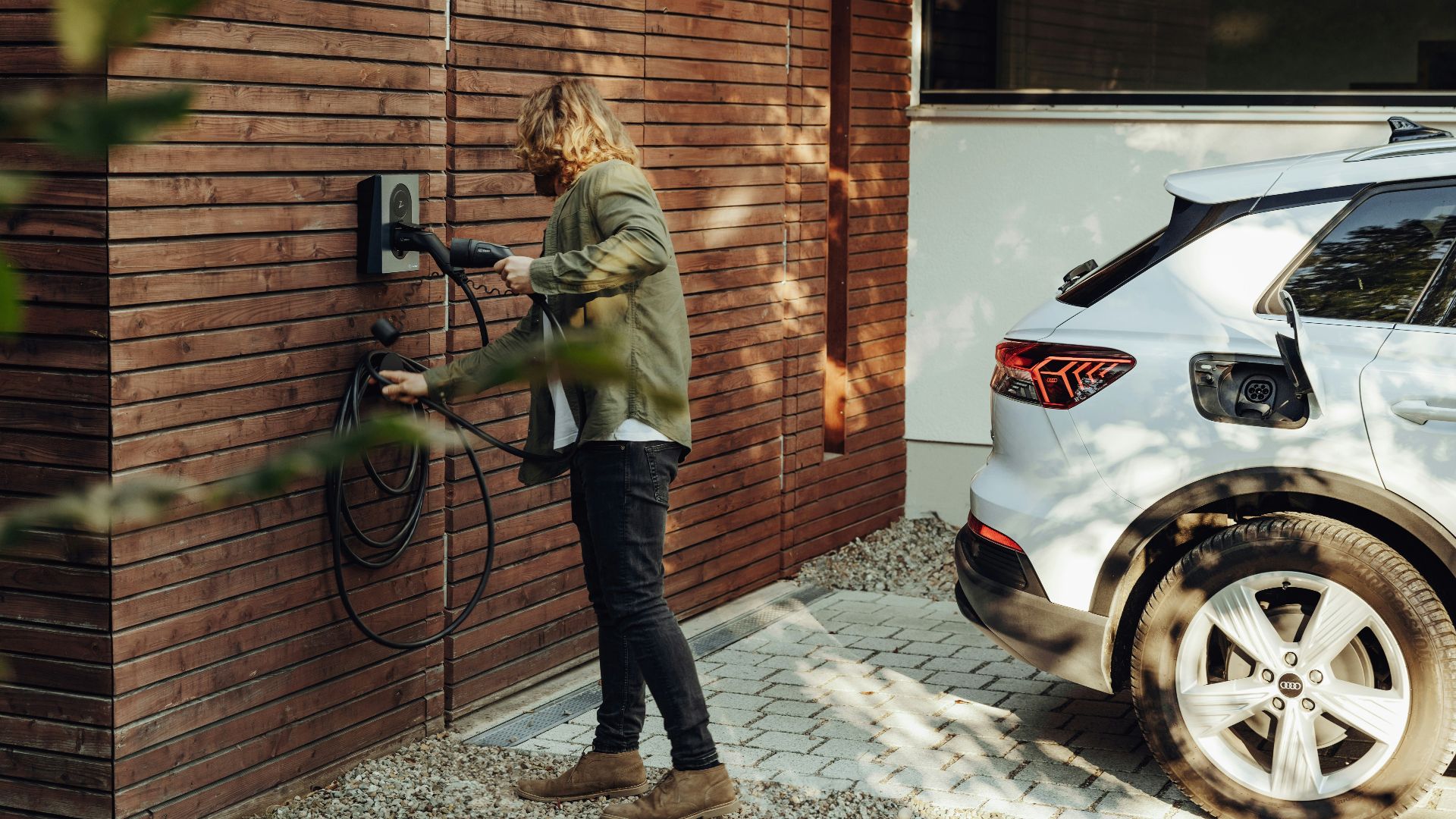 a woman is using a power washer on a brick wall