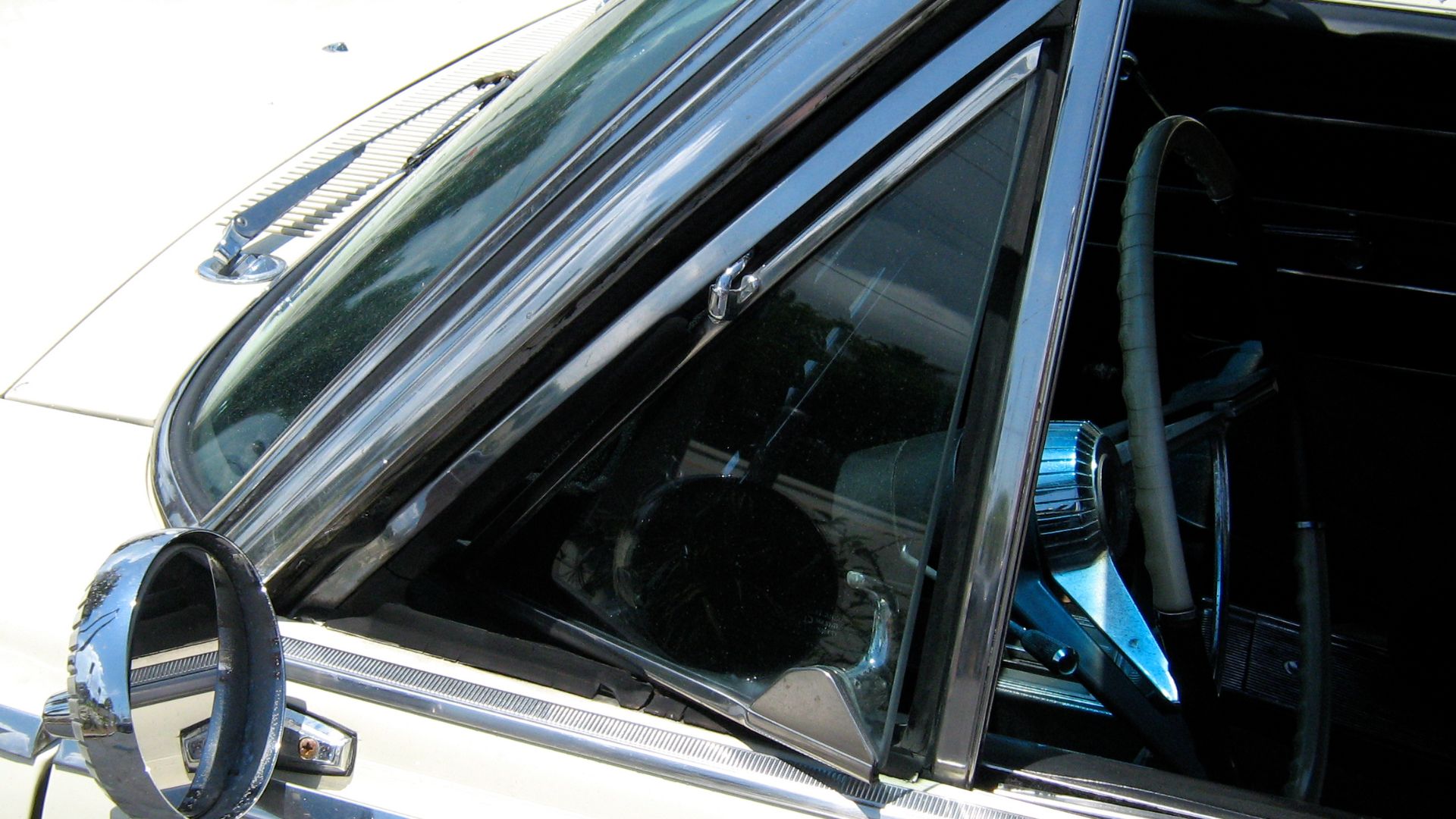 American Motors (AMC) 1965 Rambler 990 Ambassador convertible. Detail of driver's side vent window and the factory (remote adjustable) outside rear view mirror.