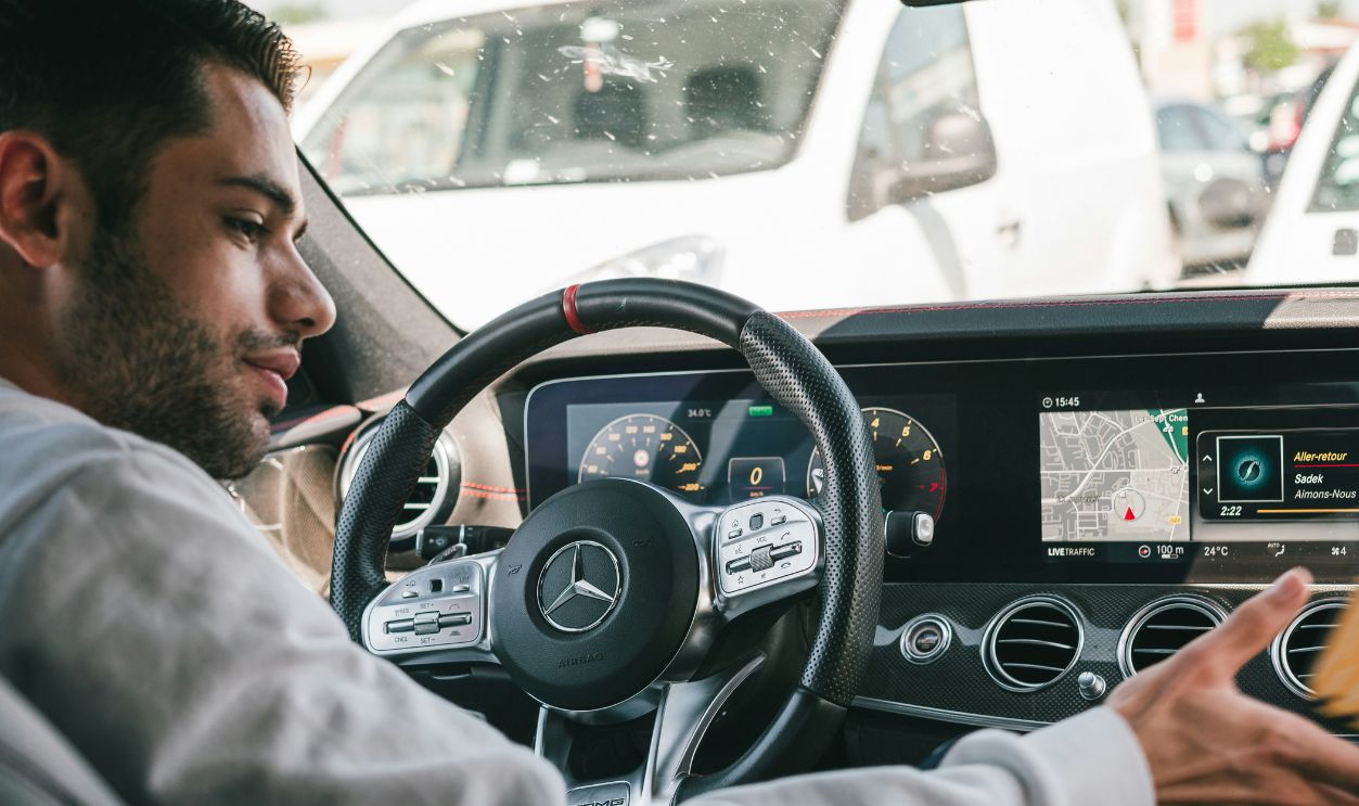 Man in gray sweater driving