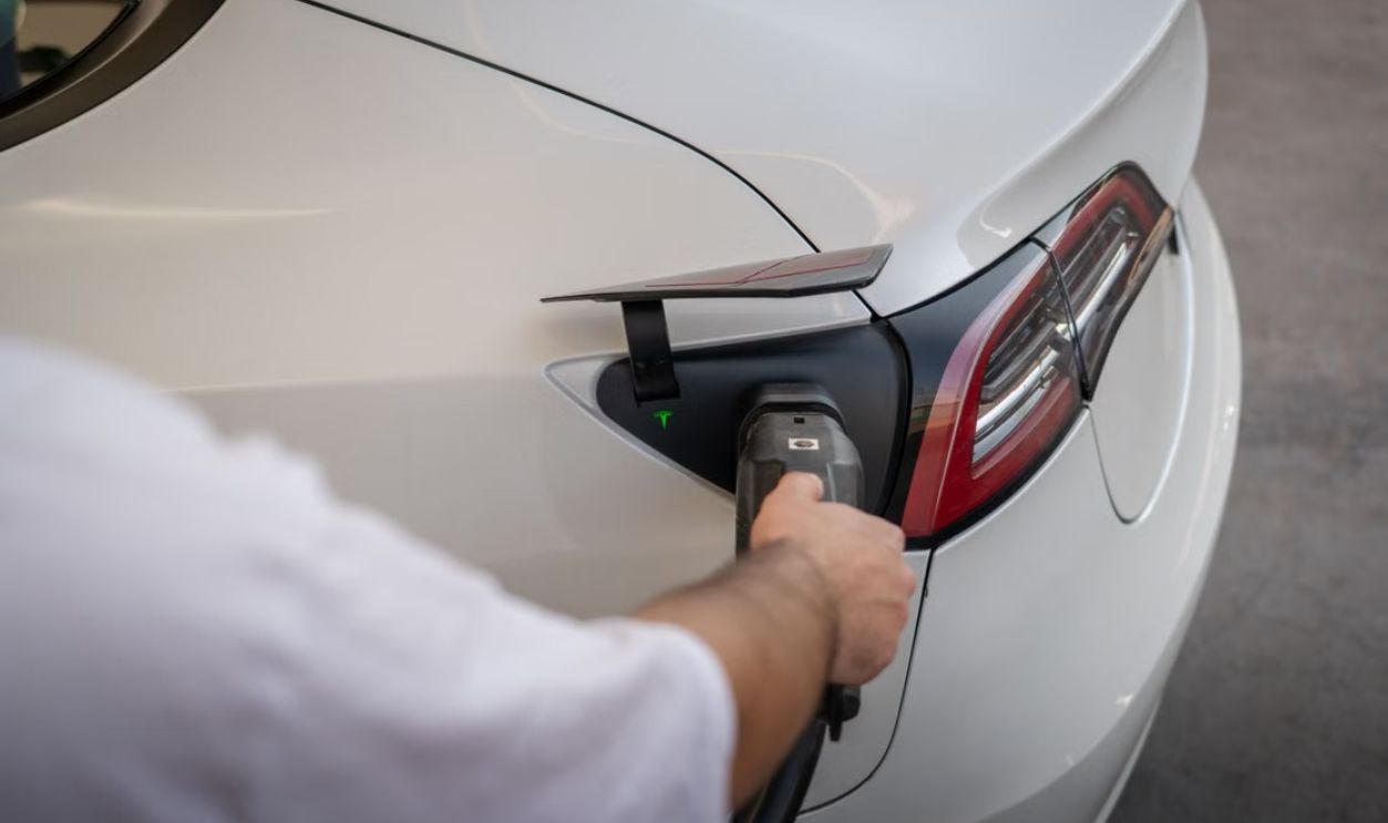 Close-up of an electric car being charged, emphasizing modern sustainable technology