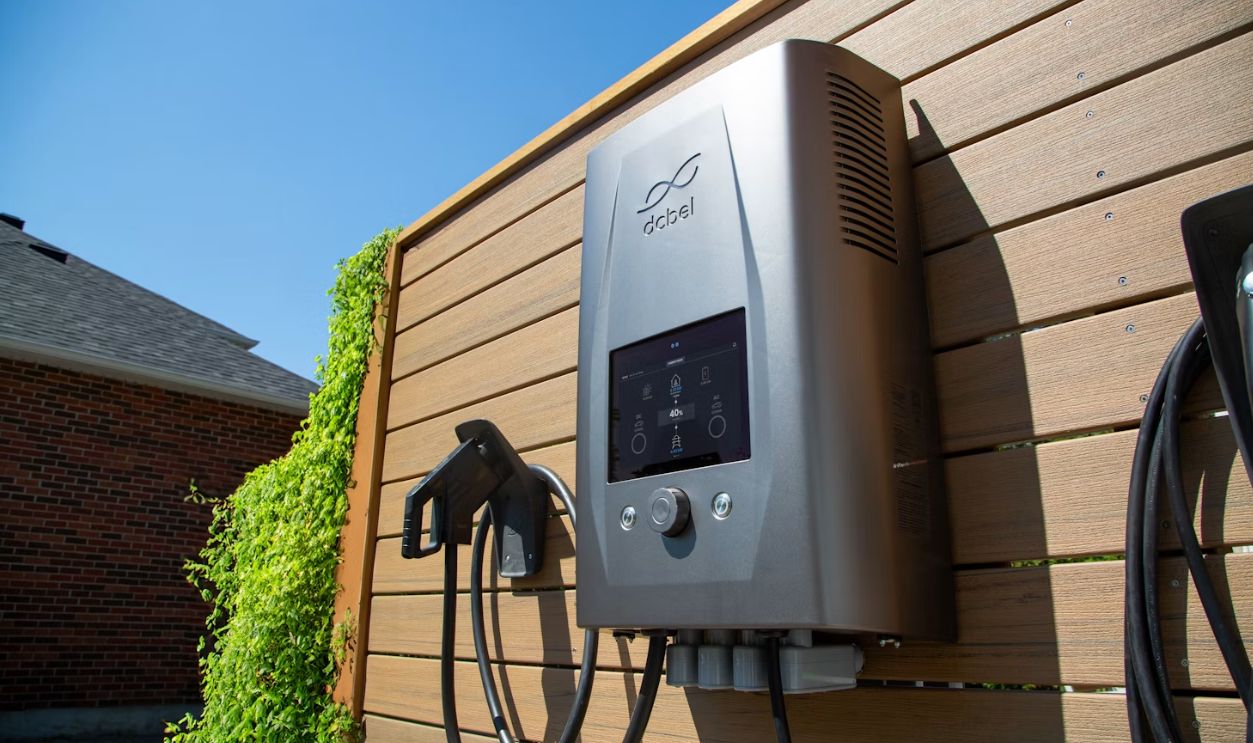 Electric car charger mounted on a wooden wall