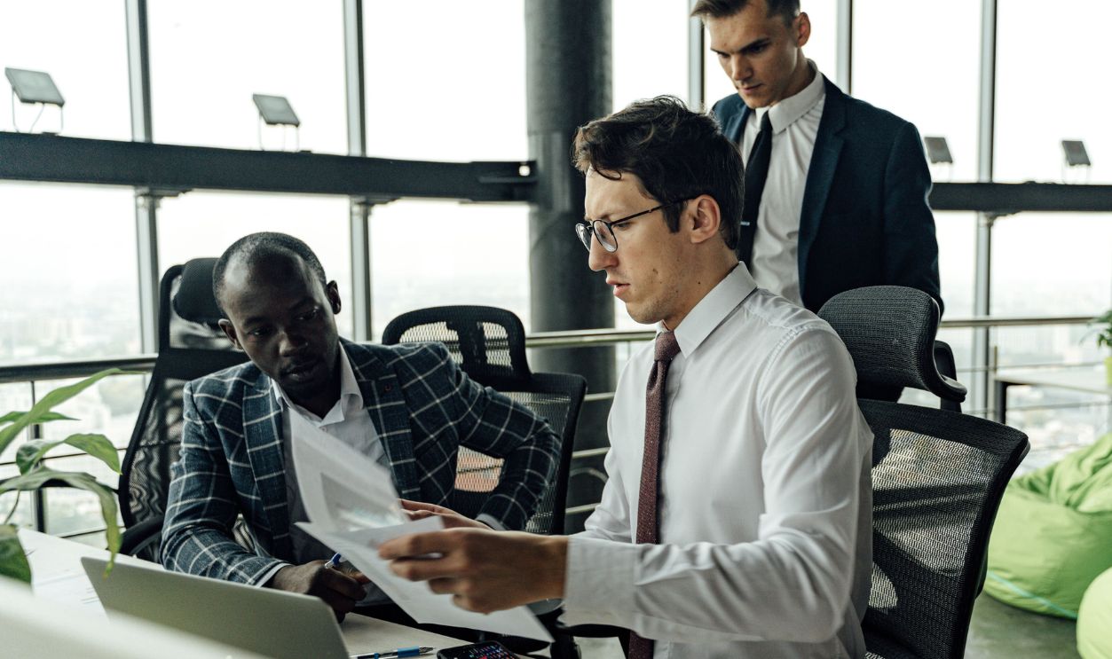Professionals engaging in teamwork and discussion in a contemporary office setting