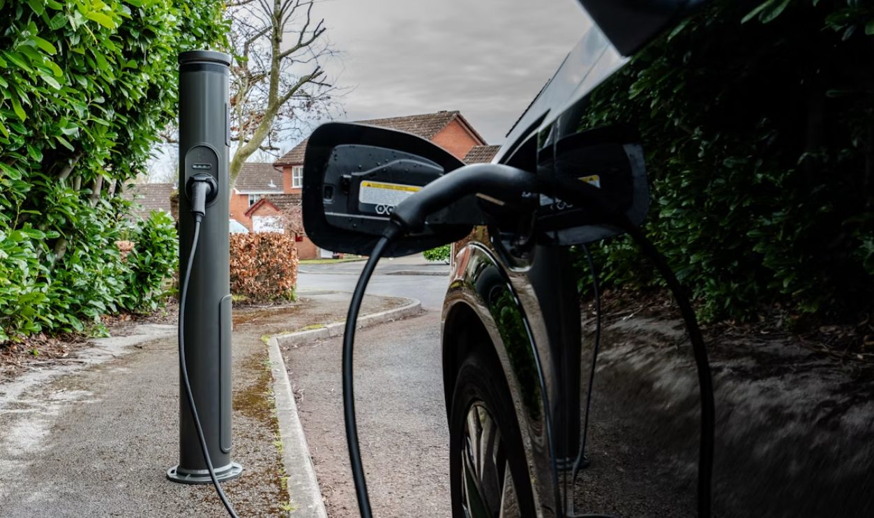Electric car plugged into a charging station outdoors