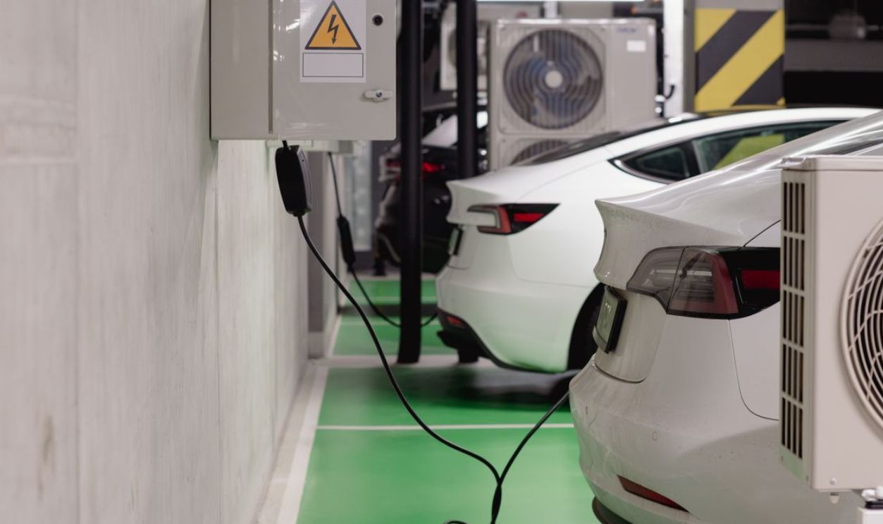 Electric vehicles charging at an indoor station in a modern underground garage