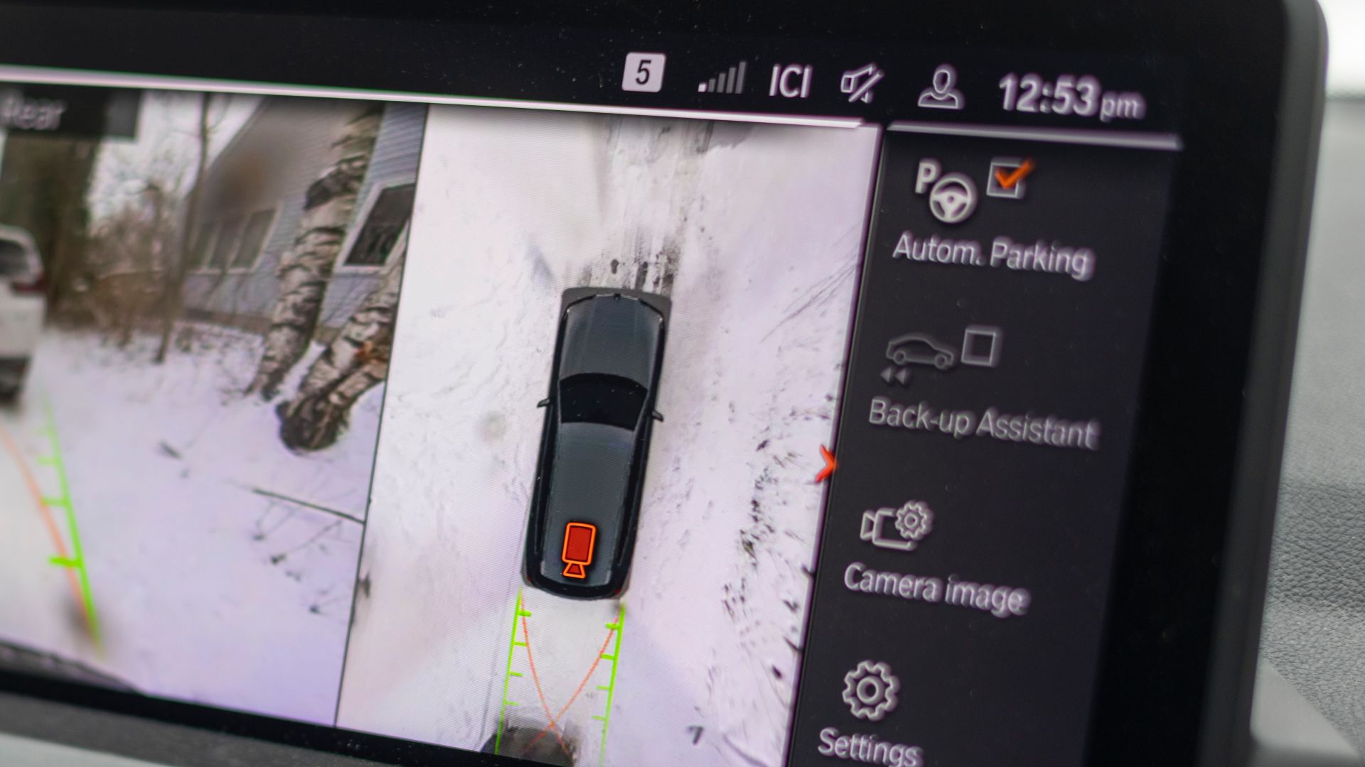 A vehicle infotainment screen displays a stitched 360-degree surround-view parking image with a car overlay, guidance lines, and parking camera settings.