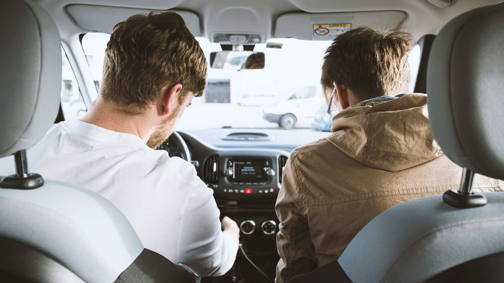 two men sitting inside vehicle