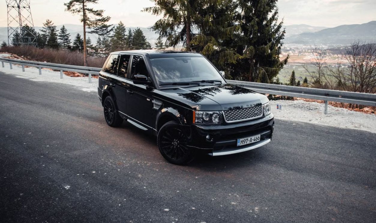 Capture of a Range Rover on a scenic highland road near Sarajevo, showcasing automotive elegance and adventure