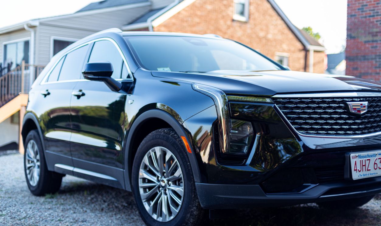 Elegant black SUV parked in a suburban neighborhood setting, with focus on modern design details