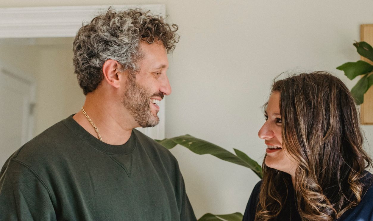 Joyful expectant couple sharing a loving indoor conversation, creating precious moments
