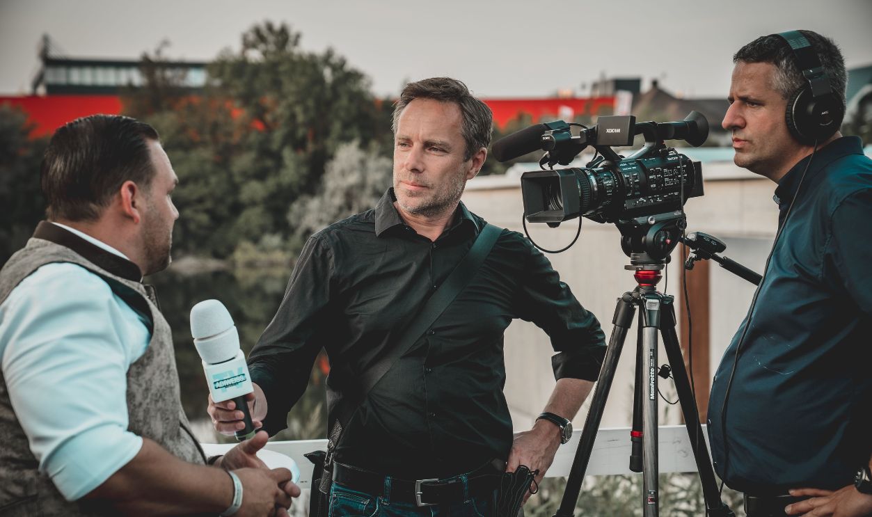 Outdoor interview with a professional news crew capturing footage