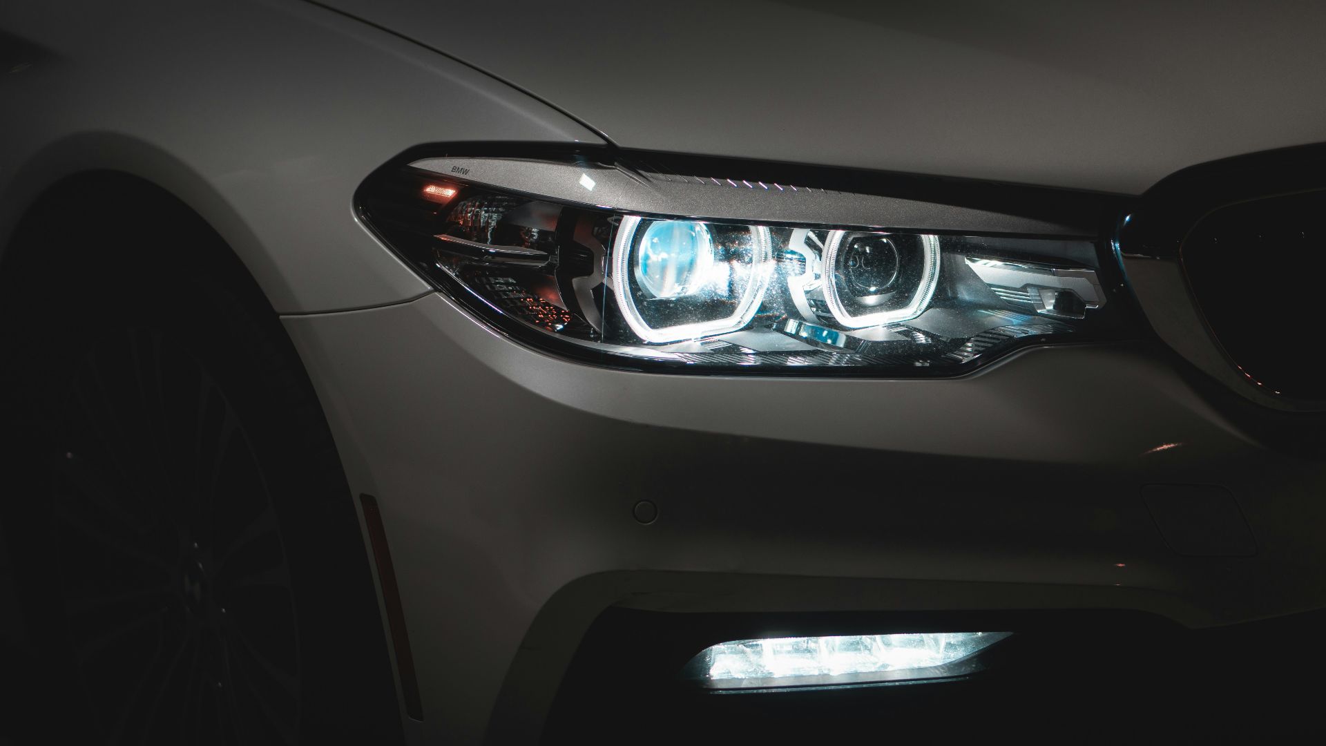 gray car with white and blue lights