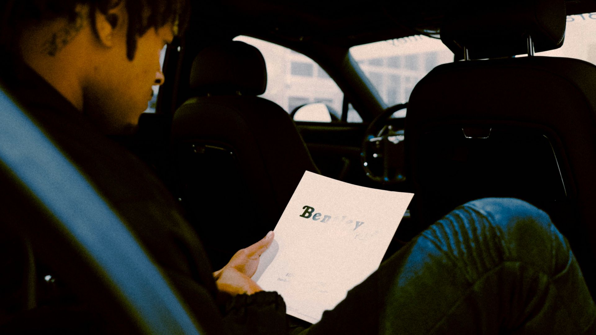 woman in green jacket sitting on car seat