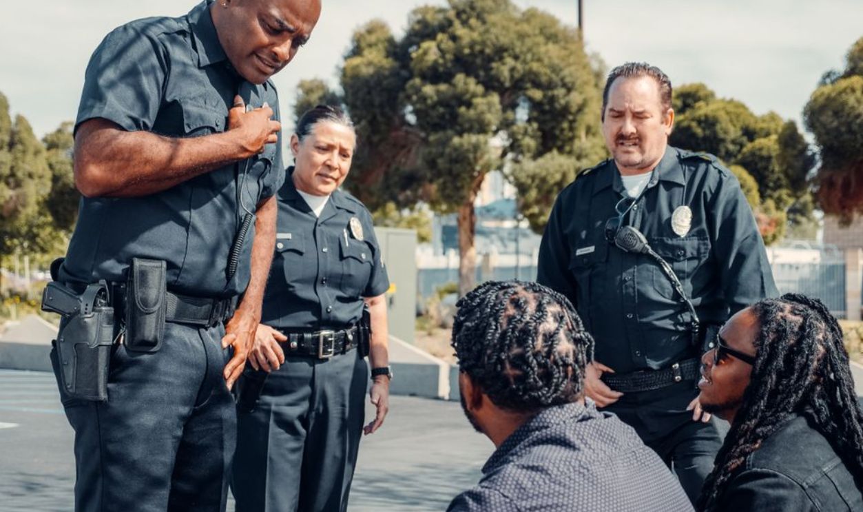 Police officers engaging with community members in an outdoor setting, promoting safety and dialogue
