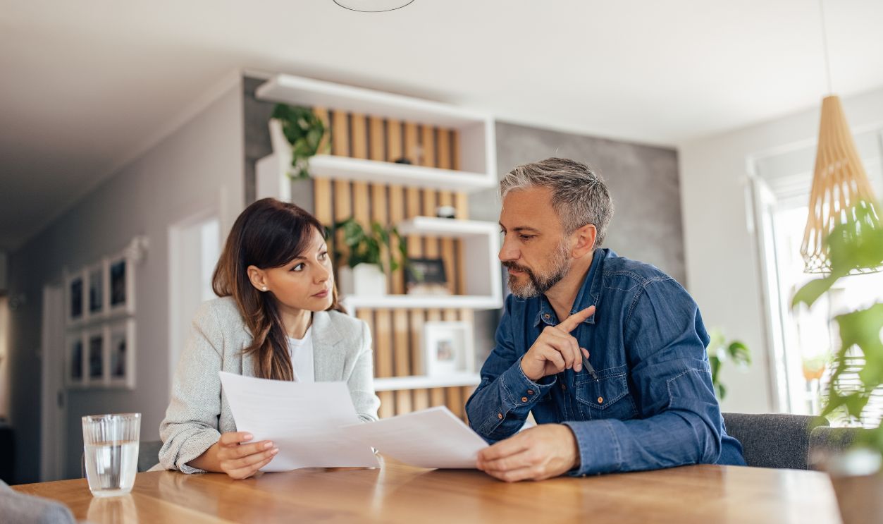 Real estate agent talking to a client about agreement or a contract.