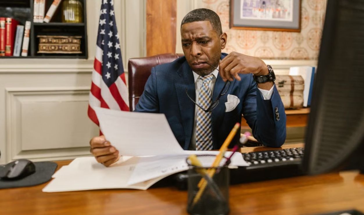 A focused lawyer reading documents in an office, symbolizing professionalism and legal expertise