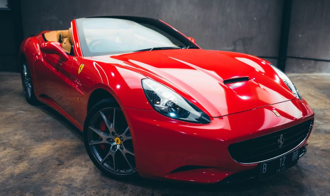 Stunning red luxury convertible car parked indoors, showcasing sleek design and elegance