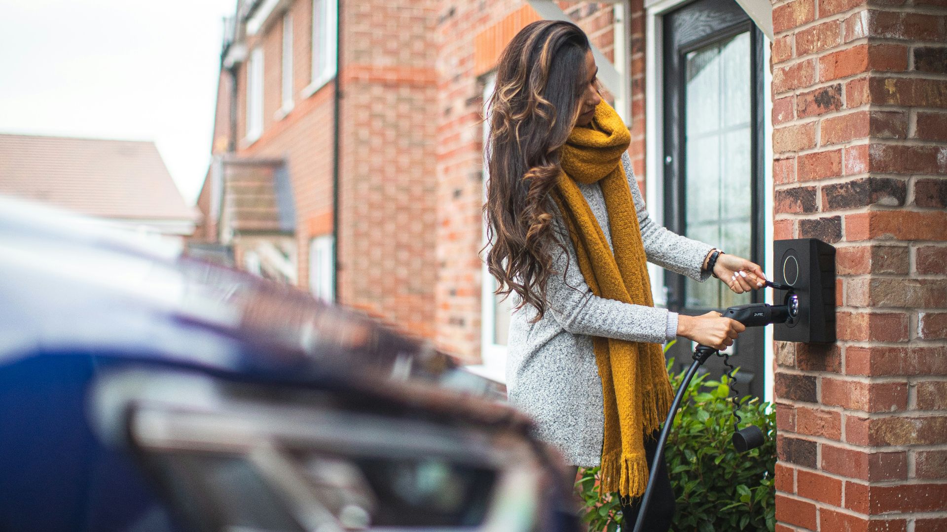 a woman is opening the door of her house