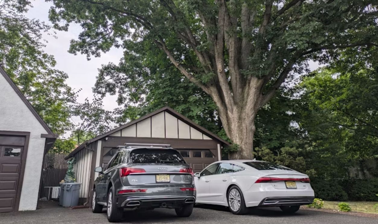 two-cars-parked-in-front-of-a-garage