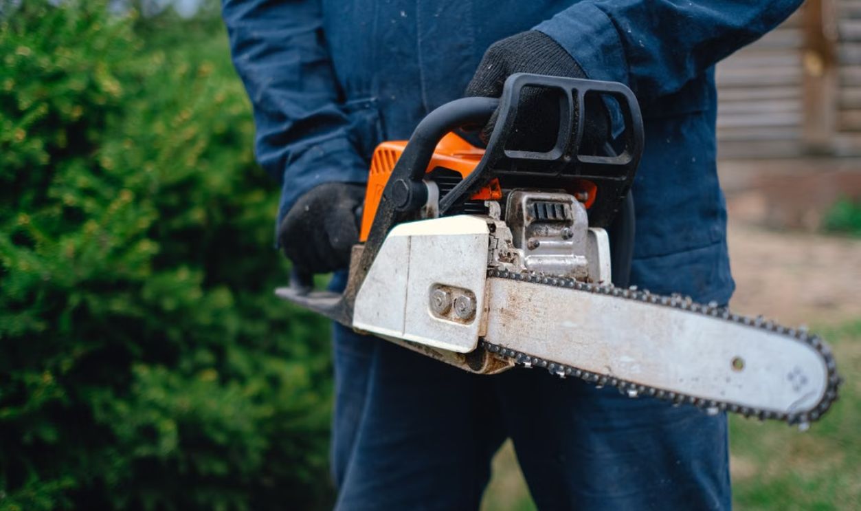 a-person-holding-a-chainsaw