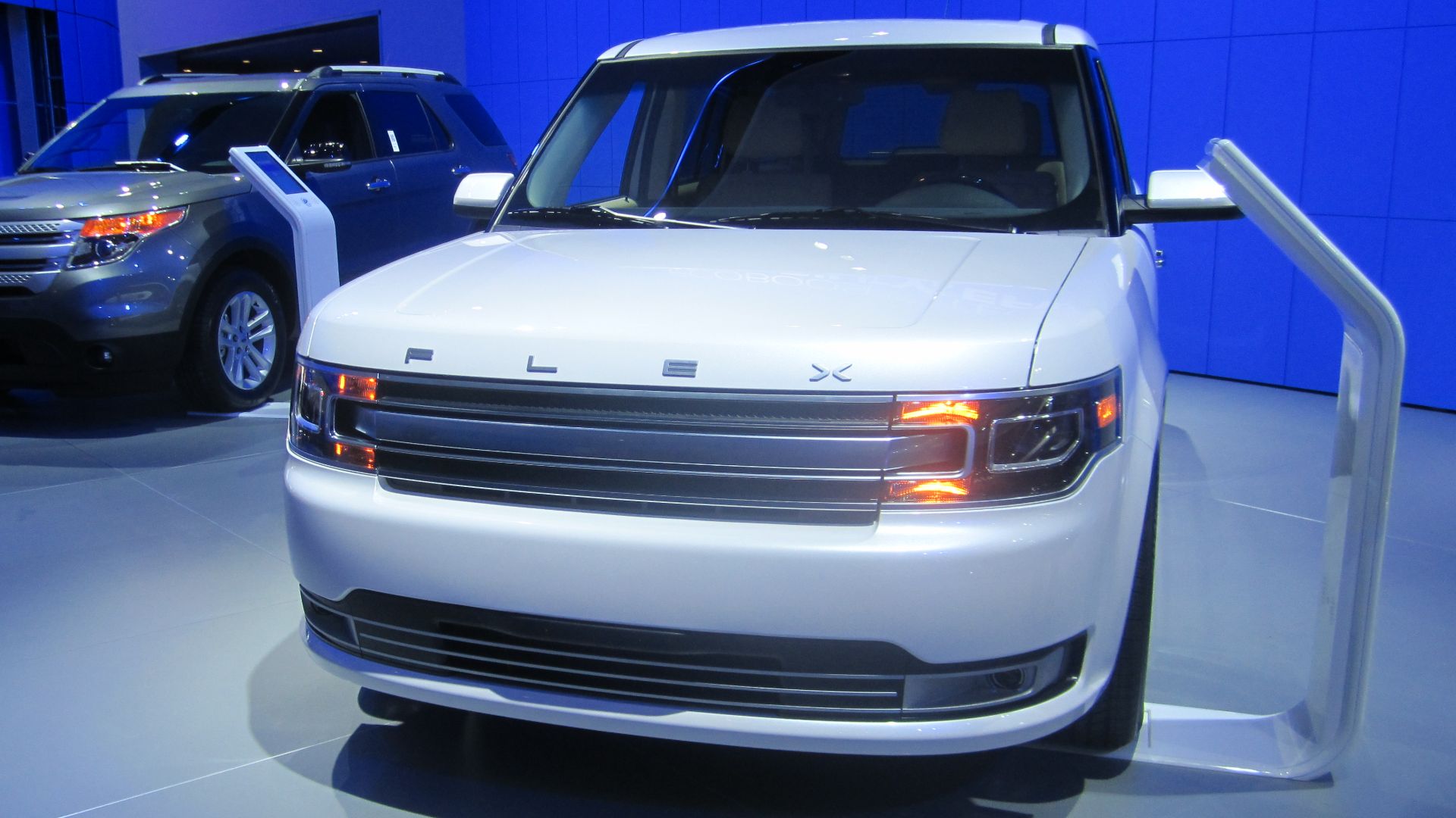 Front view of a 2013 Ford Flex (right) photographed at the North American International Auto Show at Detroit, Michigan.  Vehicle on left is a 2012 Ford Explorer.