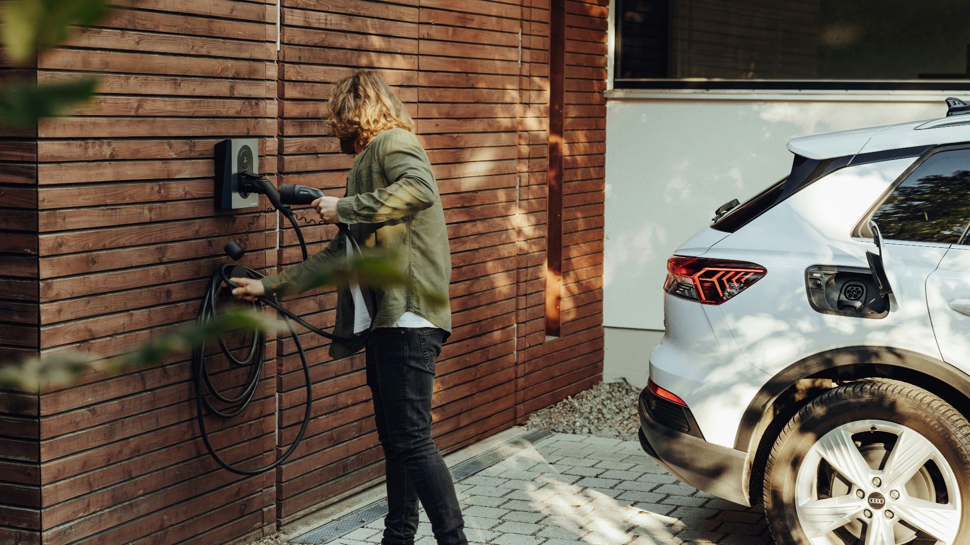 a woman is using a power washer on a brick wall