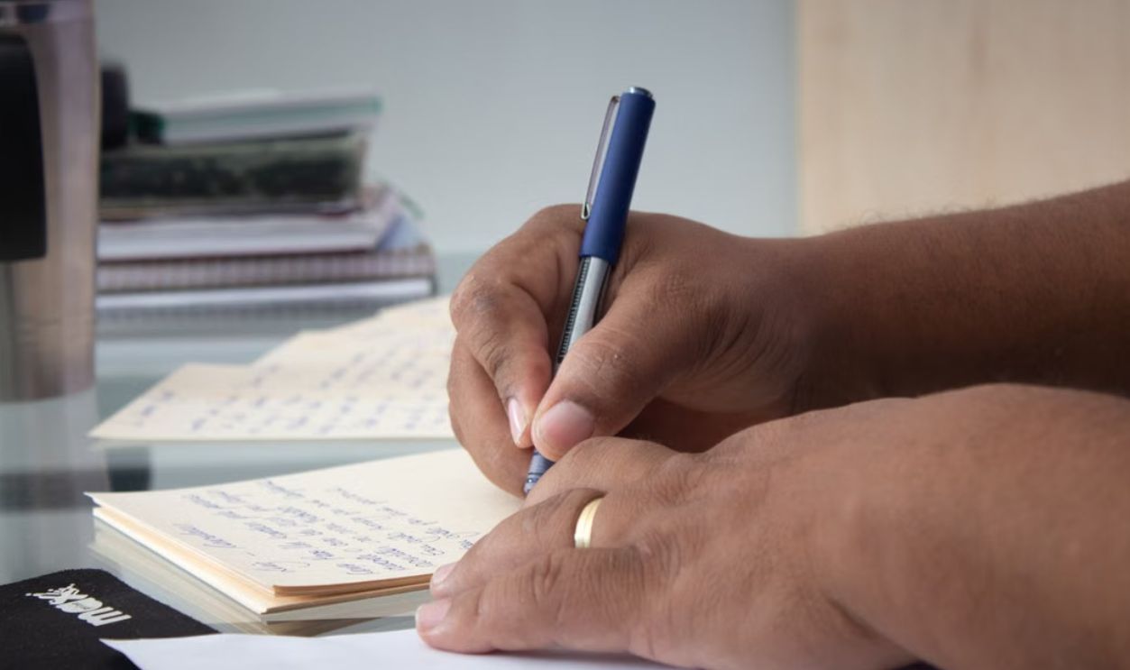 close-up-shot-a-person-writing-down-notes