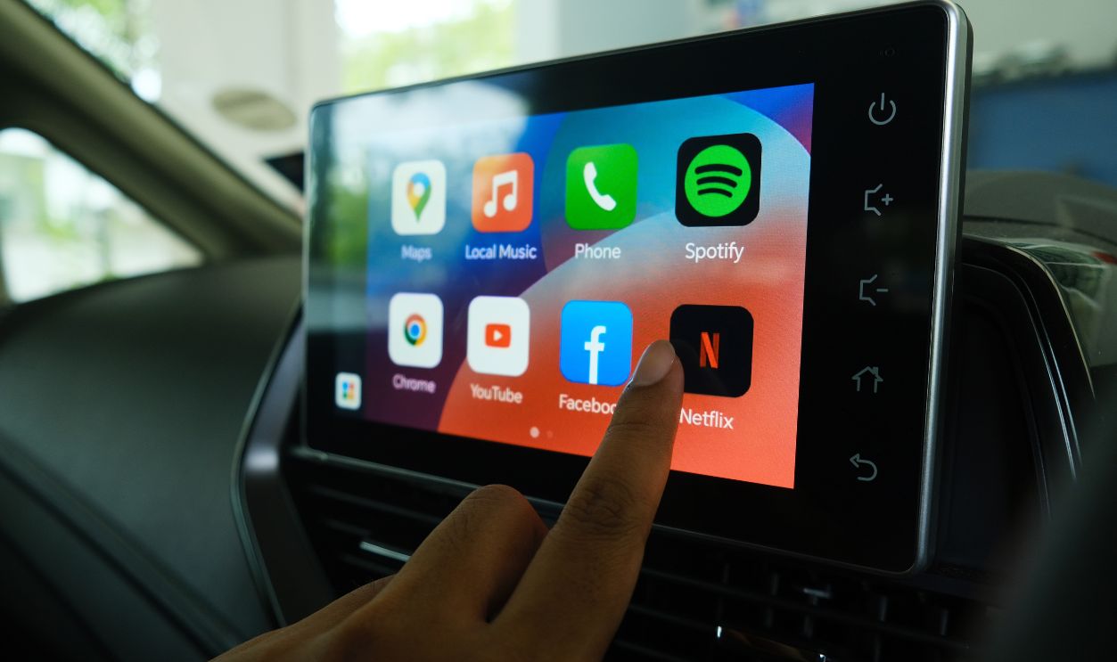 "Rimbayu, Malaysia- July 5, 2023: Selective focus with noise effect of finger choosing Netflix at car Android Infotainment Player used in B Segment Sedan car."