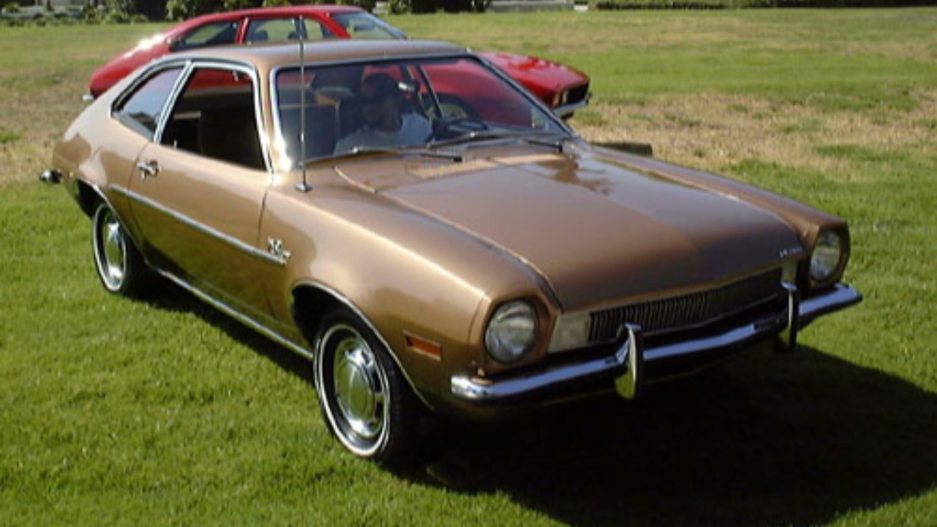 Ford Pinto.  Foreground car is a restored example; background is a hot-rodded version with popup headlights.