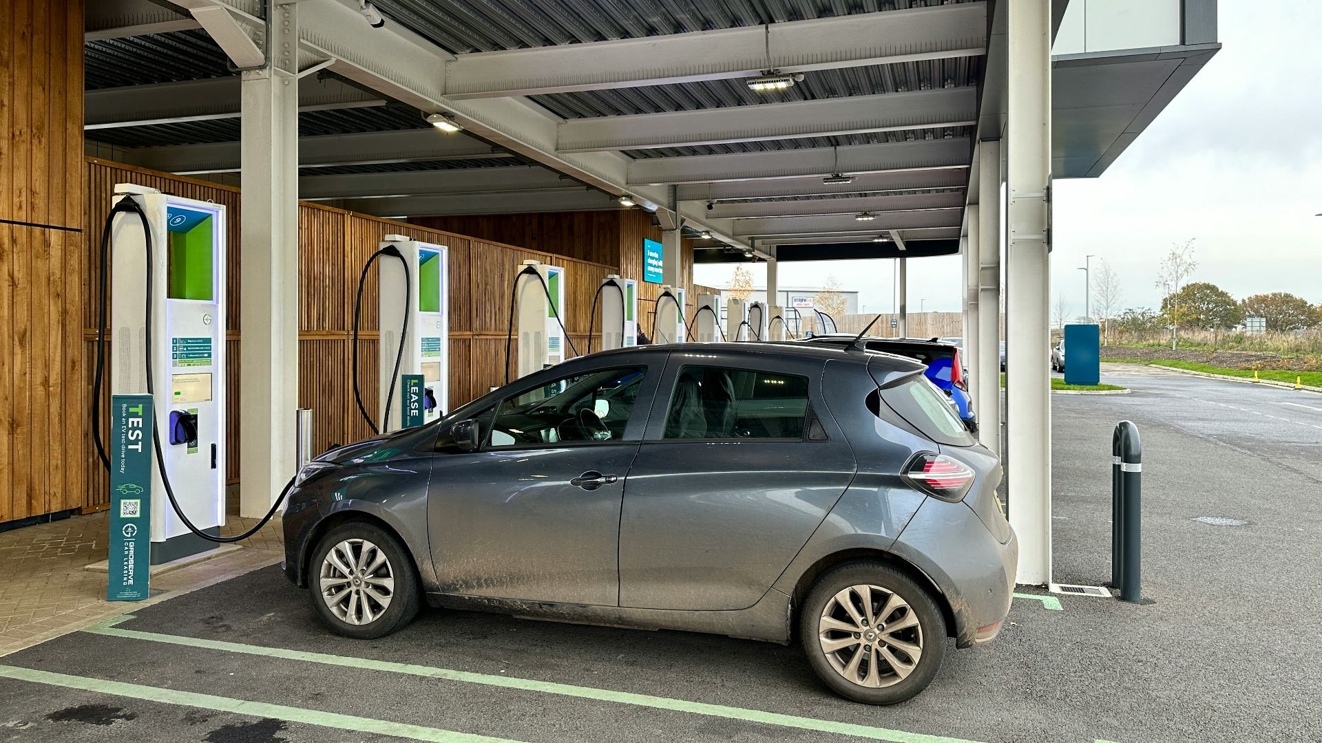 a silver car is parked at a gas station