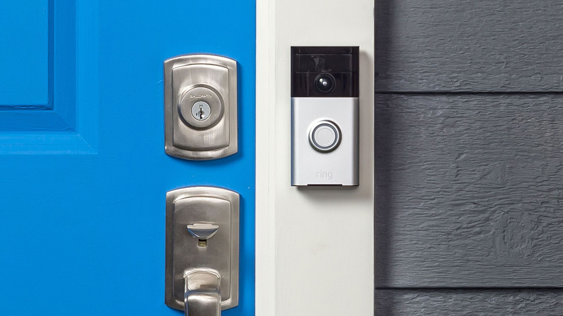 The Ring video doorbell, mounted next to the front door of a house.