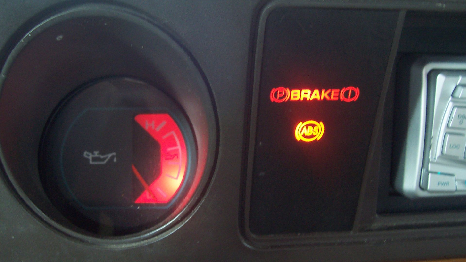 Idiot lights in a '96 Dodge Ram Van. Example of the graphical idiot lights, as well as a gauge warning.
Left side is the oil pressure gauge; when the pressure is beyond certain bounds, the gauge is illuminated in red.  Low pressure is from the vehicle not