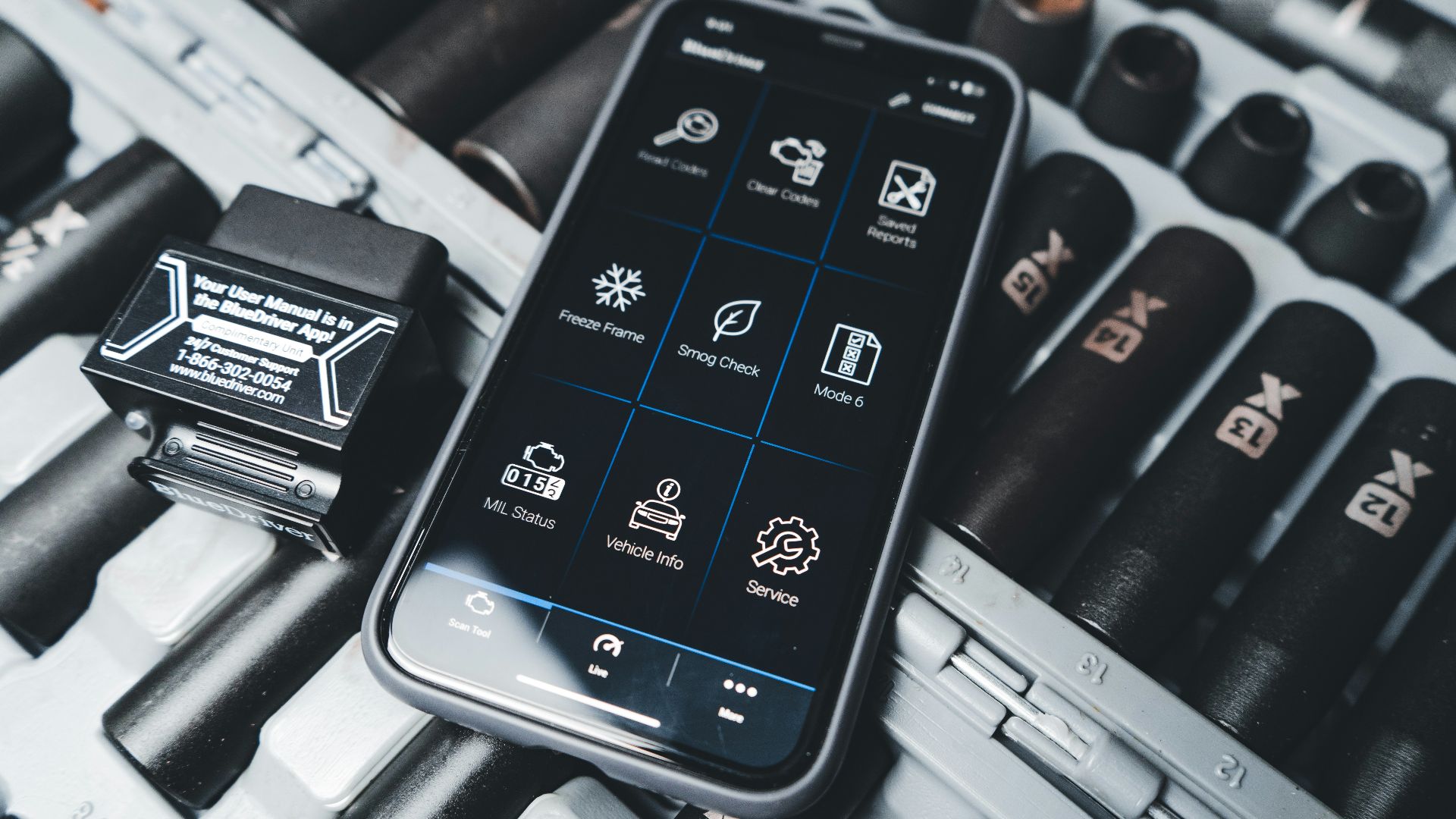 a cell phone sitting on top of a keyboard