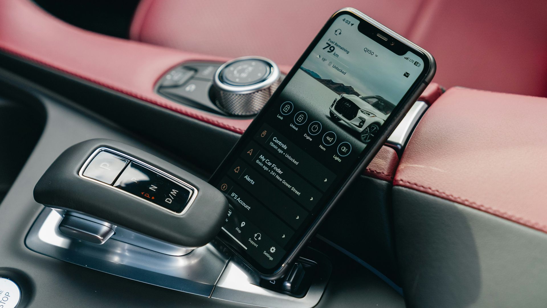 Smartphone displaying car interface in car console.