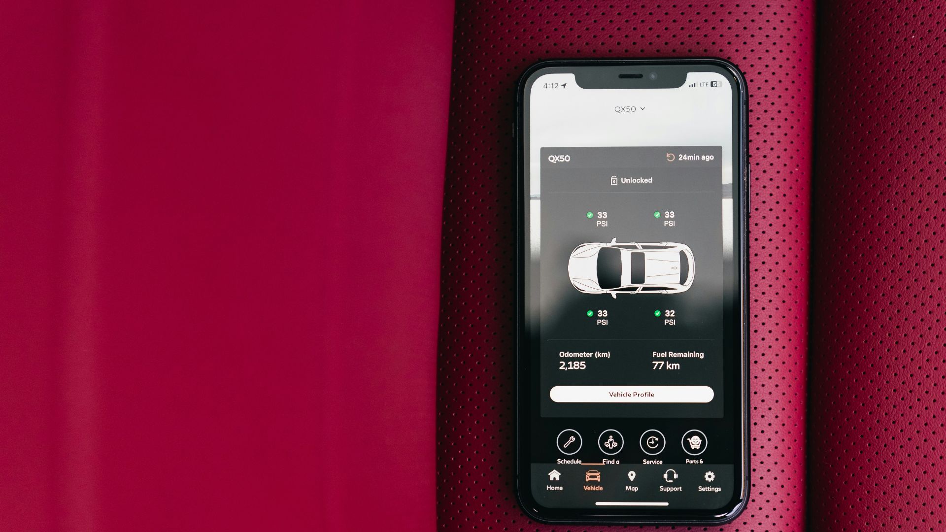 Smartphone displaying car control app on red seat
