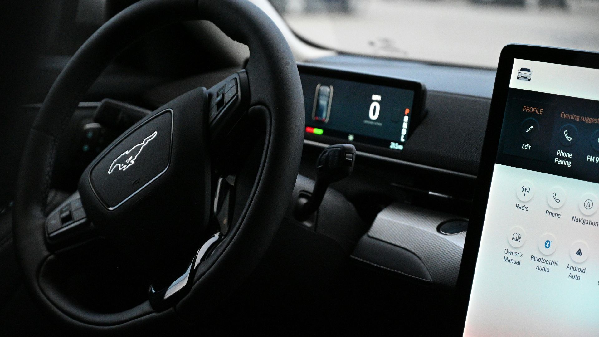 a car dashboard with a touch screen and a steering wheel