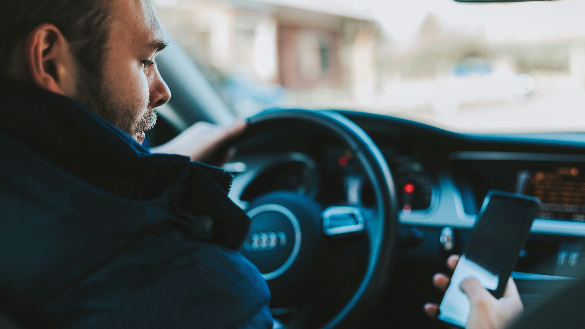 man holding black smartphone