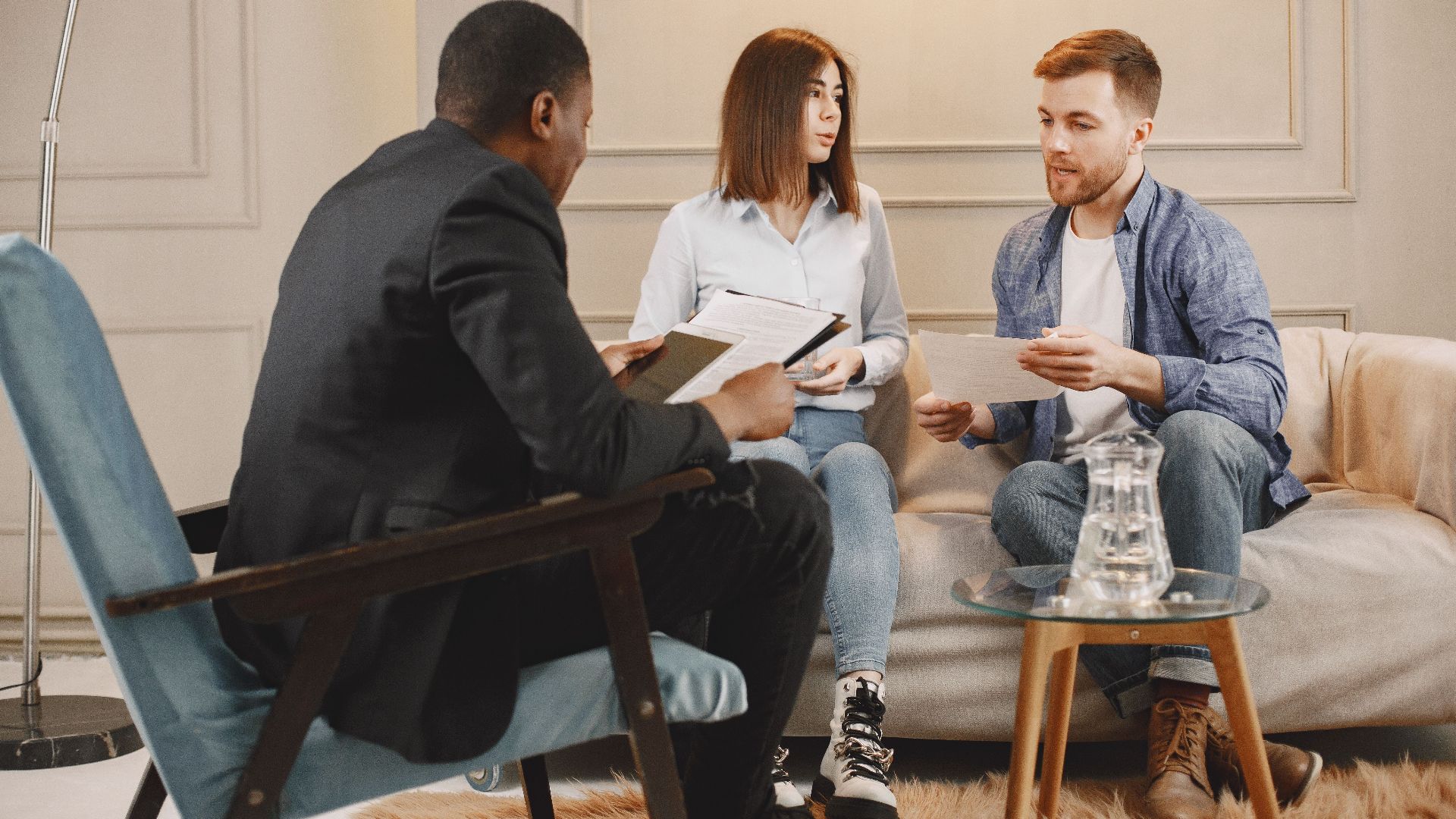A counseling session with a diverse group of adults discussing issues in a cozy setting.