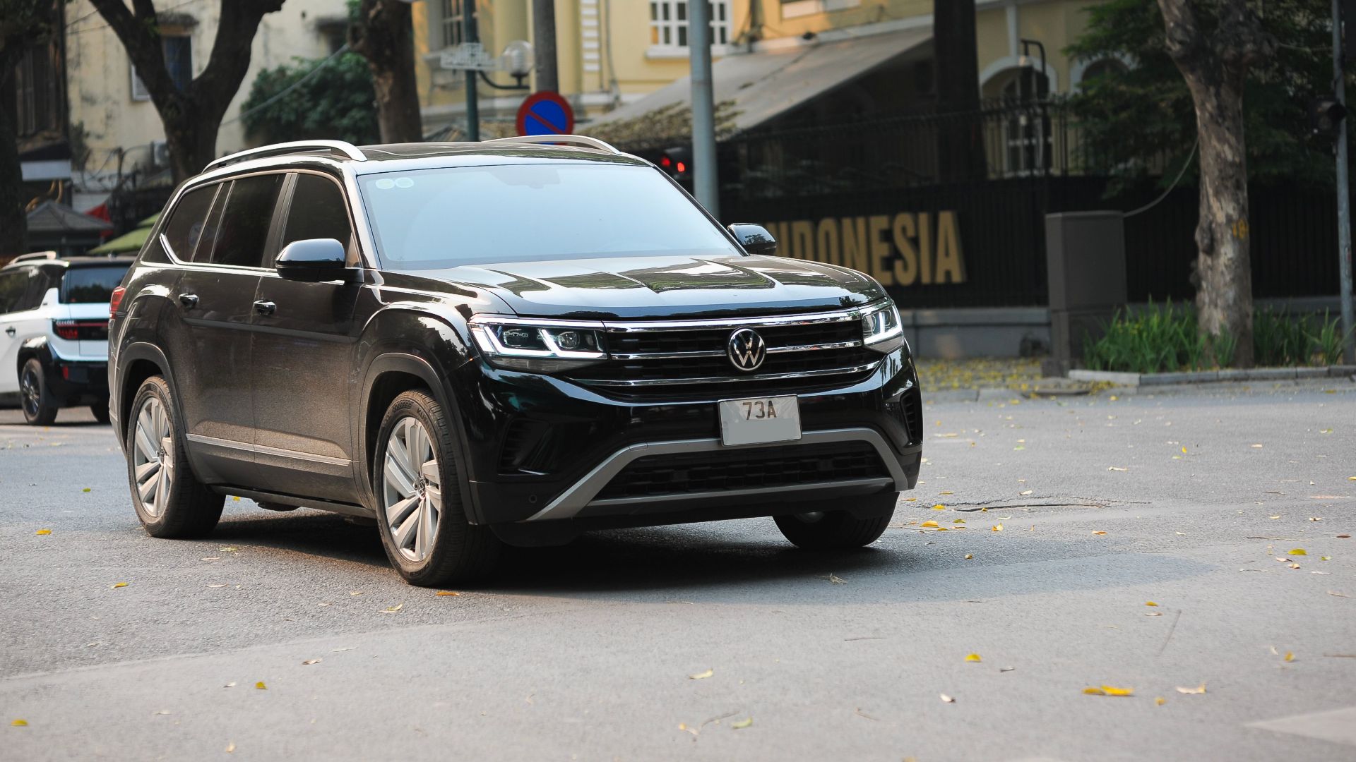 A sleek black SUV on a city street, highlighting its design and urban setting.