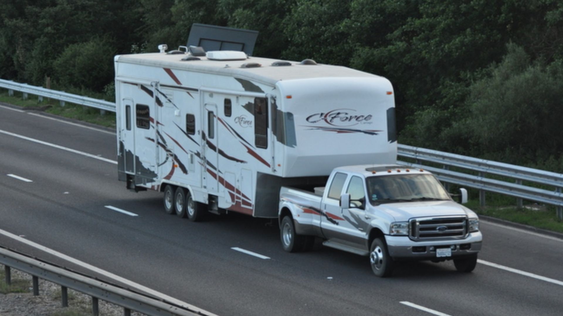 M42 - 5th wheel pick-up truck and triaxle caravan A 5th wheel American Ford pick-up truck and triaxle caravan is travelling along the M42 motorway in Warwickshire.