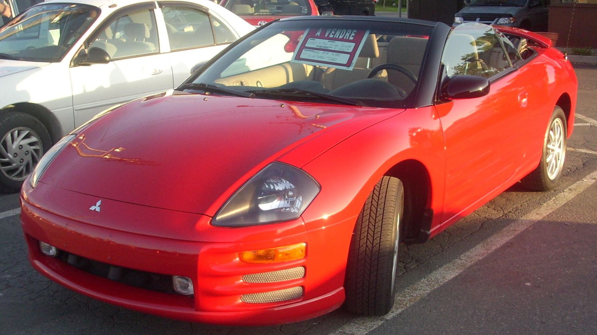 2002 Mitsubishi Eclipse Spyder photographed in Montreal, Quebec, Canada at Gibeau Orange Julep.