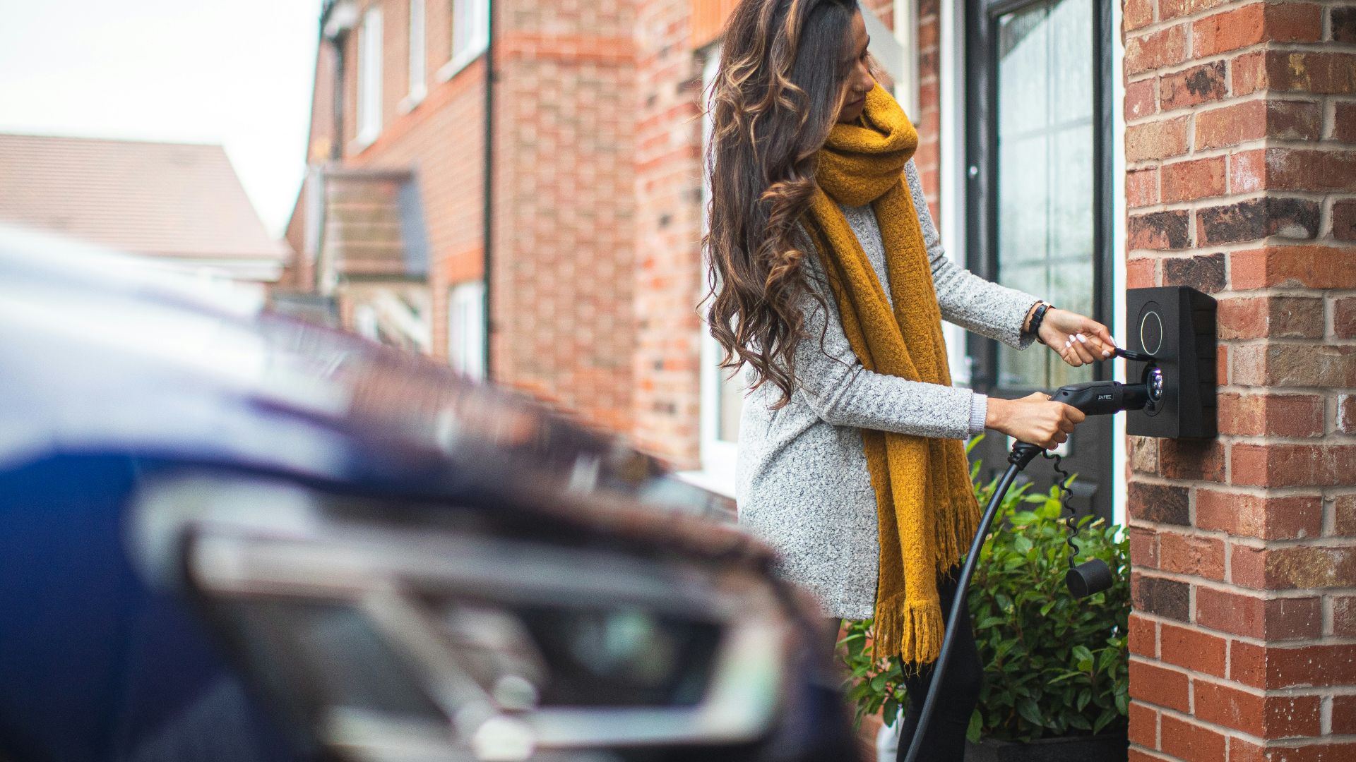 a woman is opening the door of her house