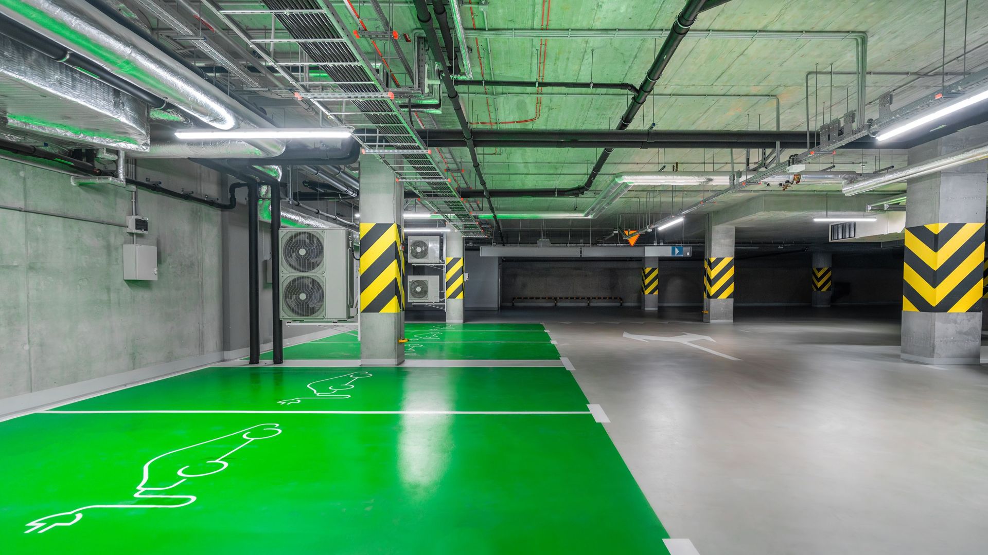 Modern green electric car charging station in an underground parking lot, eco-friendly urban solution.