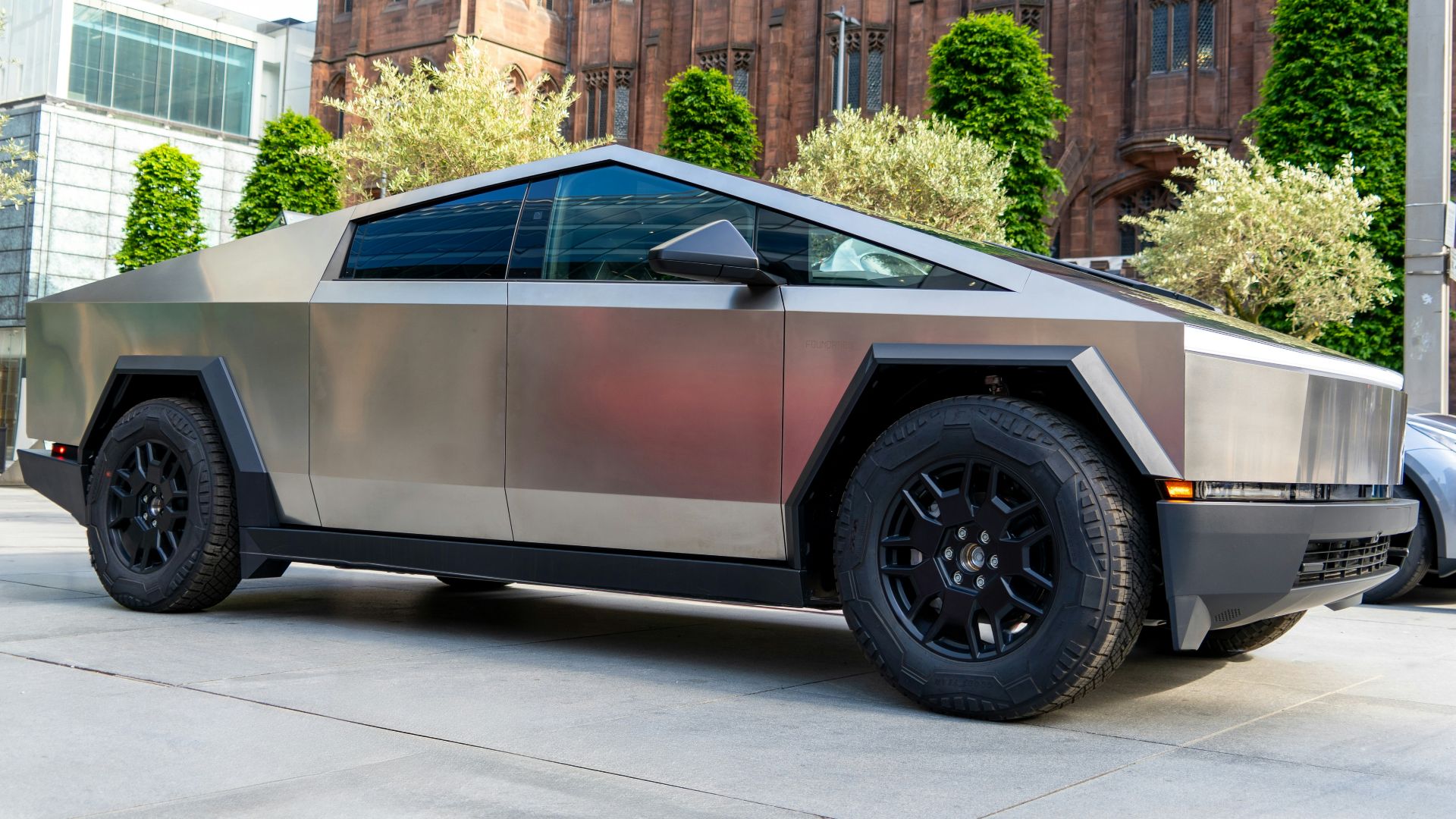 a futuristic car parked in front of a building