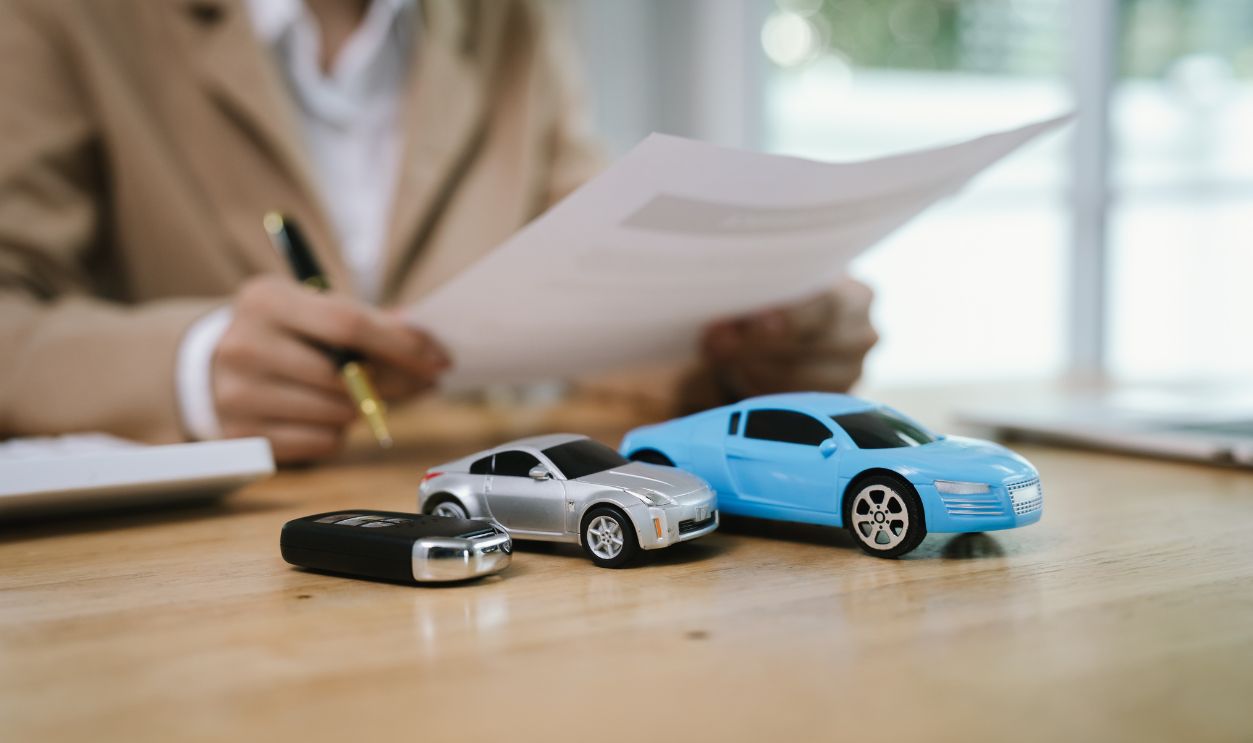A client signs a contract with a salesman, receiving car keys, symbolizing finance, insurance, purchase, investment, security, ownership, and success.